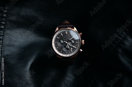 Gold LEATHER WATCH, VINTAGE STYLE WRIST WATCH, MEN'S LEATHER WATCH on leather background blur.