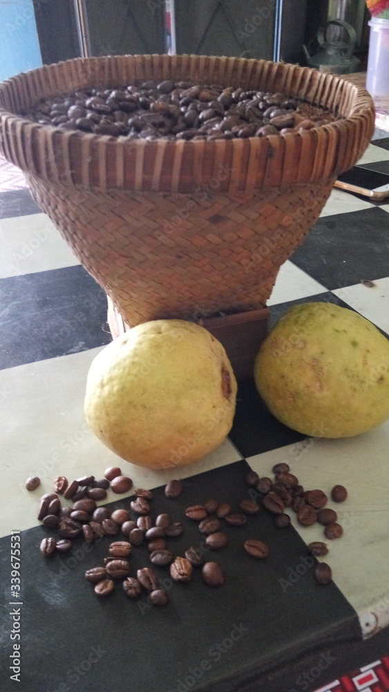 coffee beans in a basket and guava on the table coffee beans in a basket and guava on the table