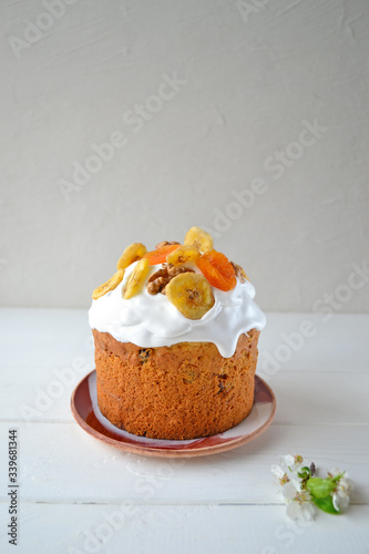 Traditional Easter cake with icing and dried fruit on top. Paska or kulich sponge cake.