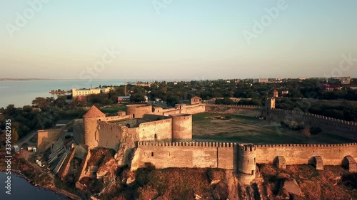 aerial View of fortress at sunset over the sea, aerial view of Akerman Fortress at sunset, Flying on drone over ancient fortress Akkerman which is on the bank of the Dniester estuary in Bilhorod photo