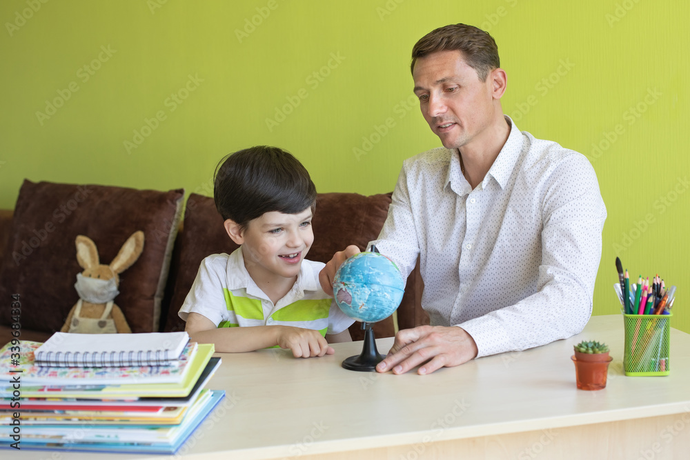 Boy with father doing homework during the coronavirus quarantine. Boy with father doing homework during the coronavirus quarantine.