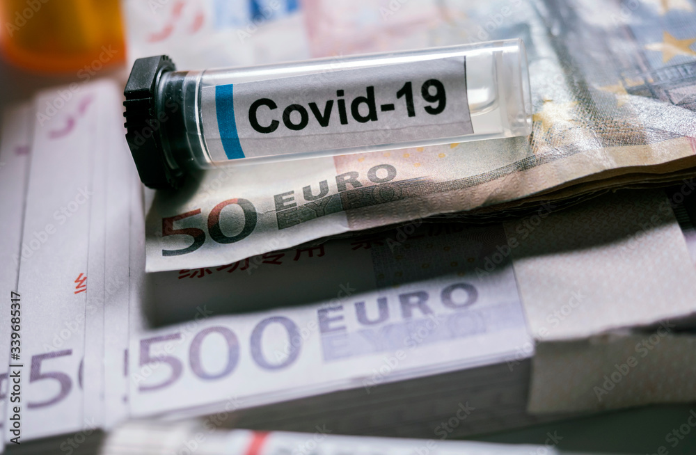 Coronavirus vial on euro banknotes, conceptual image Coronavirus vial on euro banknotes, conceptual image