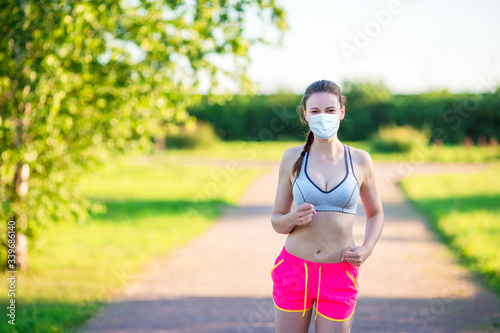 Sportive fit young woman in the park. Healthy caucasian runner girl living a healthy lifestyle.