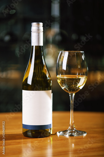 A bottle of wine and glasses on the table, against the background of a wine shakafa. Serving and serving wine. Winemaking concept, copy space.