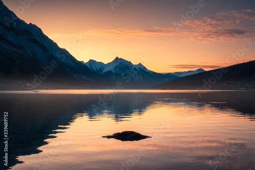 Sunrise on Canadian rockies with rocks on Medicine Lake at Jasper national park © Mumemories