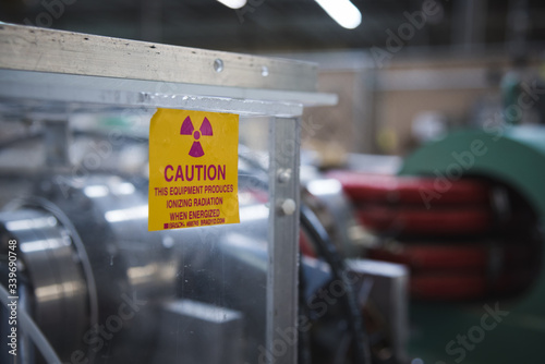 Caution Radioactive Warning During Scientific Experiment High Energy Magnet in Background photo
