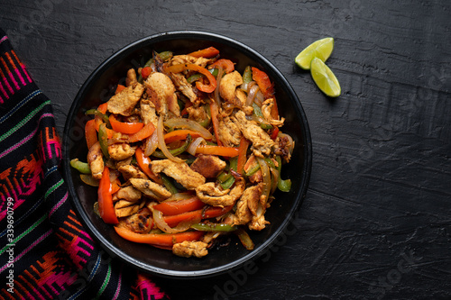 Mexican chicken fajitas on dark background