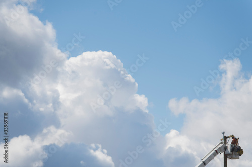A lineworker is shown working on a utility pole