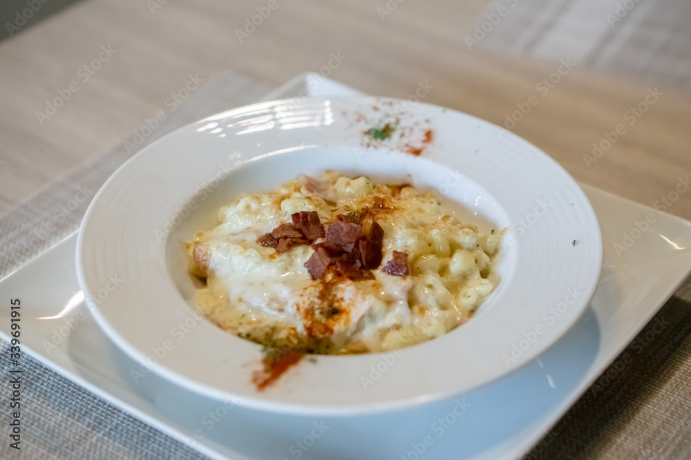 Angle top of macaroni and cheese top with bacon. Angle top of macaroni and cheese top with bacon.