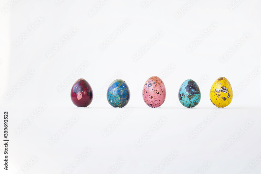 On a white background are painted eggs. Real hand-painted eggs. A multi-faceted photo. Holiday and joy of Bright Easter for the whole family