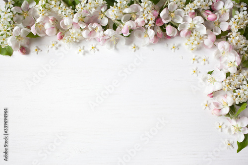 Spring background with blooming apple tree branches, bird cherry, for congratulations, text
