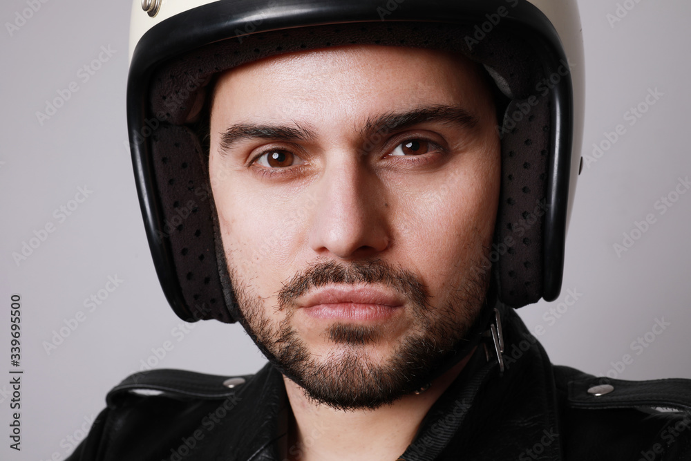 Handsome bearded man over white background with serious face wearing white helmet. Handsome bearded man over white background with serious face wearing white helmet.