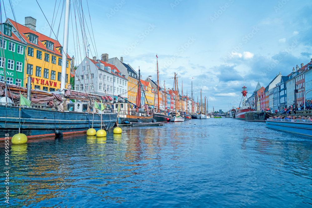 Copenhagen, Denmark - Sep 3, 2016: Nyhavn is Copenhagen’s old port, where H.C. Andersen lived. Colorful houses standing by the waterfront.