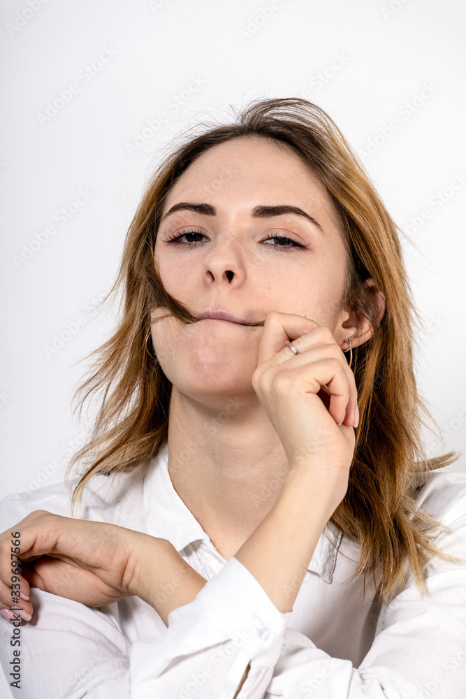 close-up portrait of a young girl playing with hair on a white background close-up portrait of a young girl playing with hair on a white background