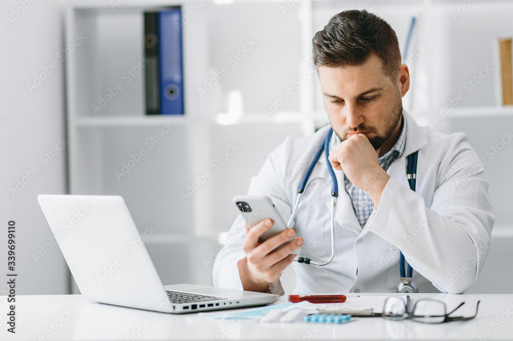Young handsome doctor in gloves with patient online consultate Young handsome doctor in gloves with patient online consultate
