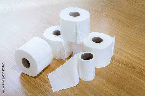 toilet paper stacked on wooden floor