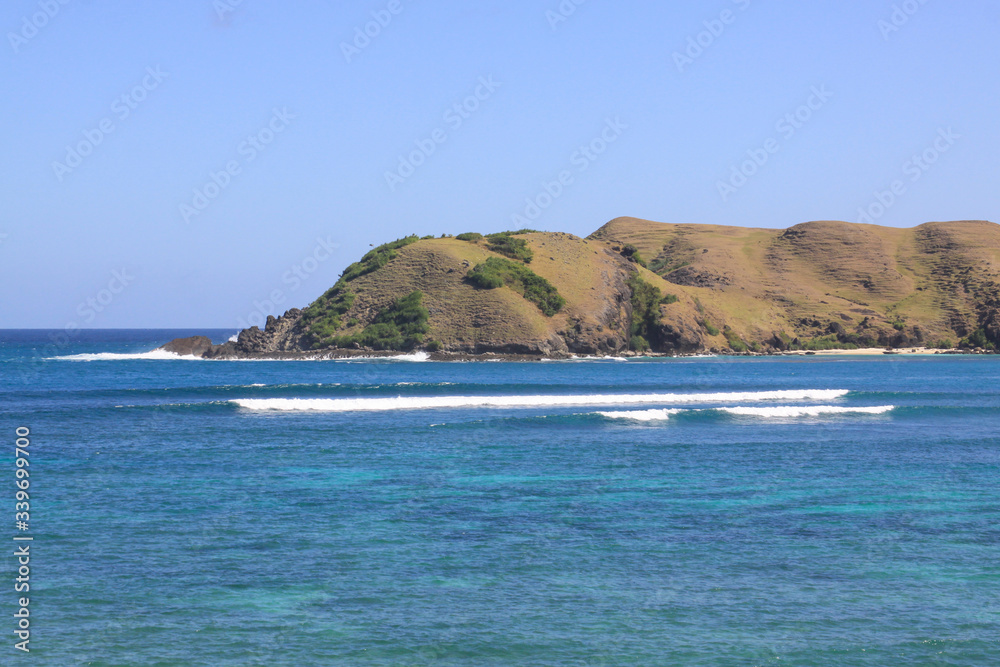 Surfing waves at Kuta beach, Lombok, Indonesia Surfing waves at Kuta beach, Lombok, Indonesia