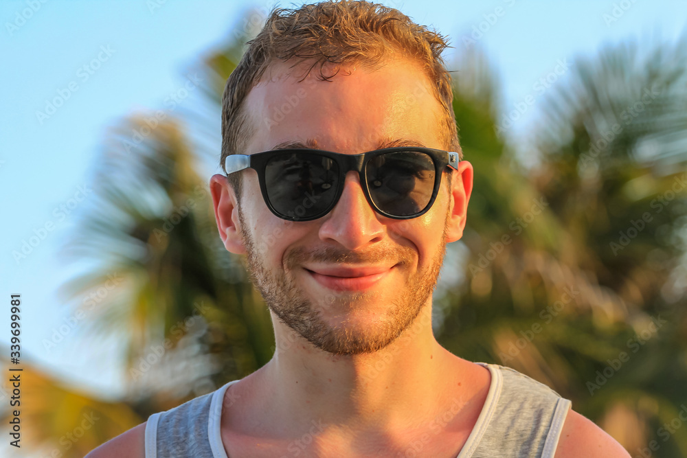 young handsome bearded guy in black sunglasses close up, looking to camera young handsome bearded guy in black sunglasses close up, looking to camera