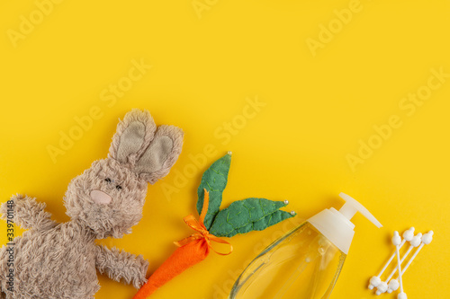 Fototapeta Naklejka Na Ścianę i Meble -  Teddy bunny and bath accessories on yellow background.