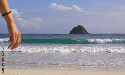 Female hand and wave background at Mawun beach photo