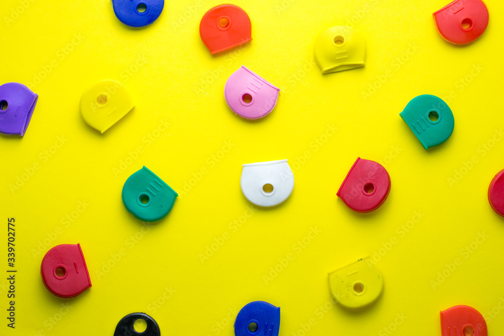 colorful rubber key covers on a yellow background colorful rubber key covers on a yellow background