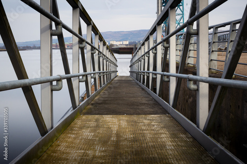 A gangway down to the river Clyde near Glasgow in the west of Scotland on a cold winter morning. 