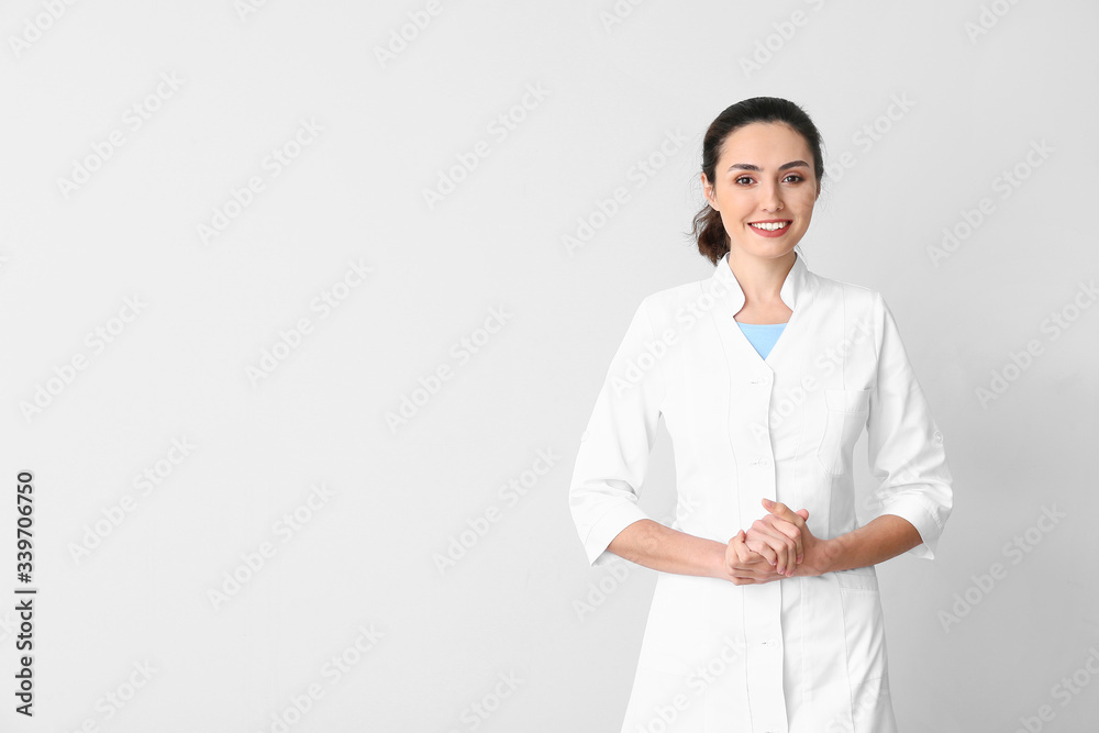 Portrait of young female doctor on light background Portrait of young female doctor on light background
