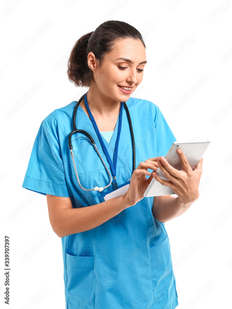 Young female doctor with tablet computer on white background