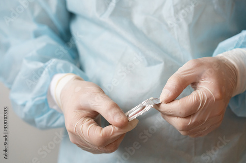 a doctor in medical gloves holds a vaginal candle  rectal candle for hemorrhoids  antipyretic