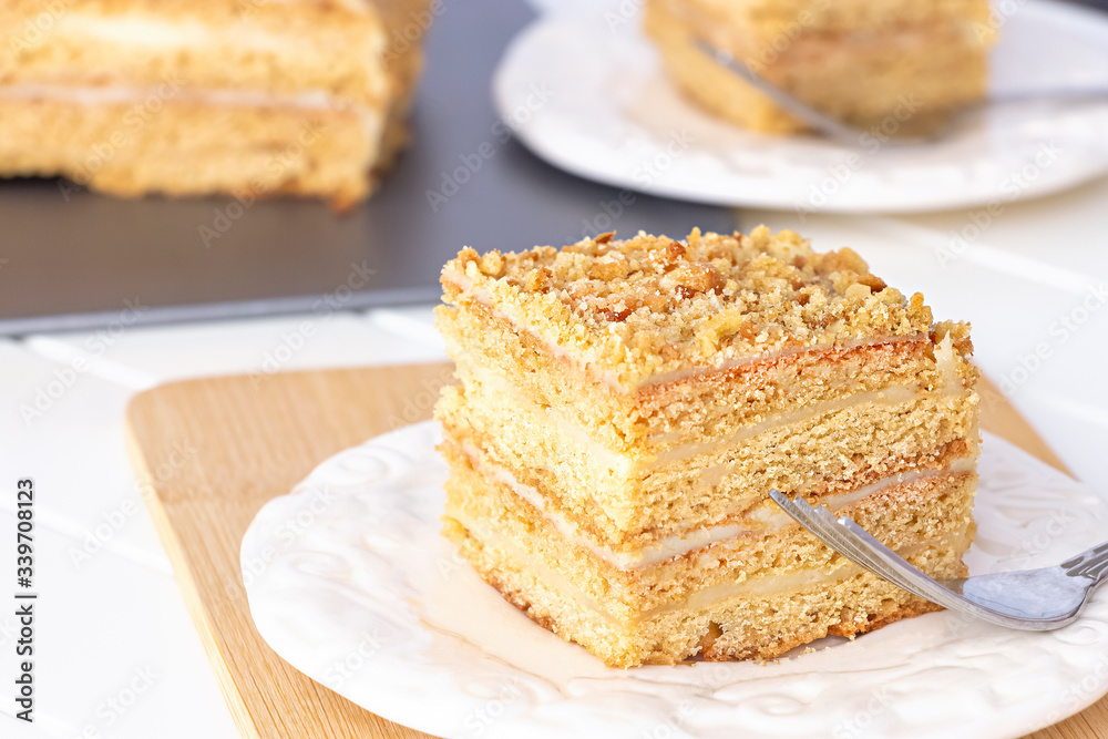 Two pieces of homemade honey cake on white wooden table. Selective focus. Two pieces of homemade honey cake on white wooden table. Selective focus.