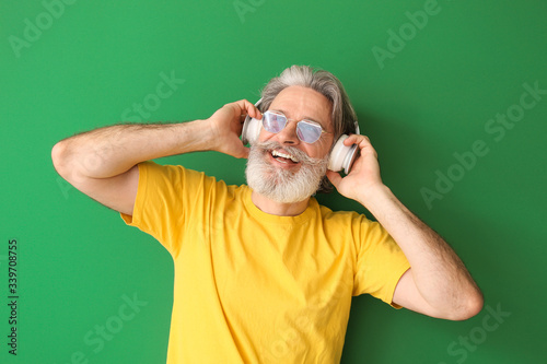 Happy elderly man listening...