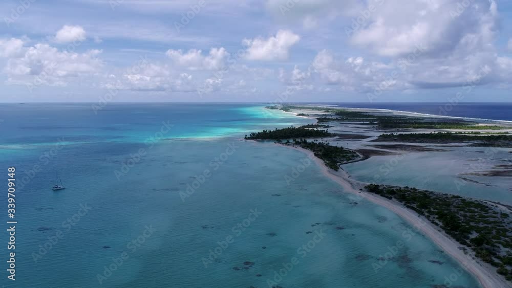 Amazing drone flyover shot of pink sand and turquoise blue water of the Tikehau lagoon, French Polynesia. Clouds, blue sky, Palm trees fill the scenic South Pacific landscape of pink beaches Amazing drone flyover shot of pink sand and turquoise blue water of the Tikehau lagoon, French Polynesia. Clouds, blue sky, Palm trees fill the scenic South Pacific landscape of pink beaches