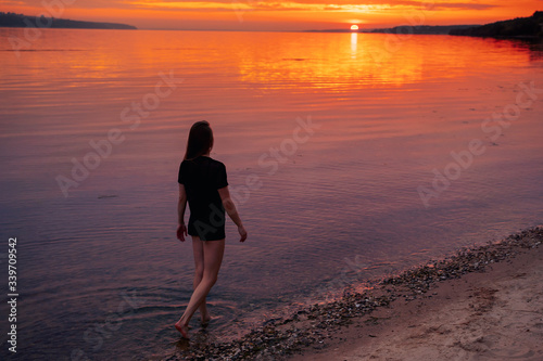 girl doing pilates, yoga on the beach, at sunset  © Yura