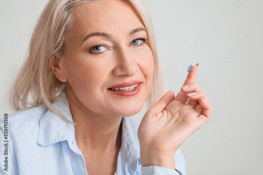 Mature woman with contact lens at home Mature woman with contact lens at home