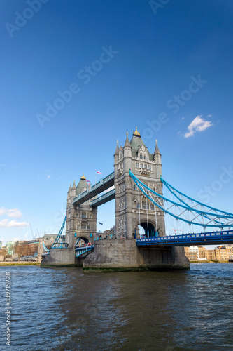 A view of the Tower Bridge in the shade during a sunny and clear day.