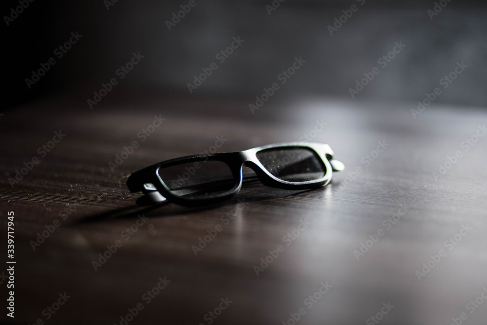 Cinema. Glasses for cinema. Wooden table. Points. Glasses lying on a wooden table.