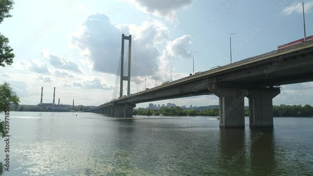 South bridge across the Dnieper in Kiev. Ukraine. Video from drone Traffic. The movement of cars and trains on the bridge. Metro. South bridge across the Dnieper in Kiev. Ukraine. Video from drone Traffic. The movement of cars and trains on the bridge. Metro.