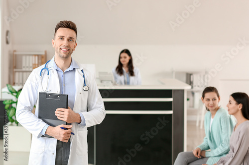 Male doctor in hall of clinic