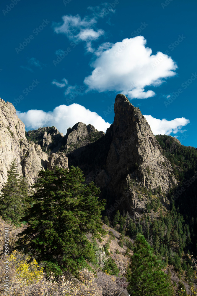 Fototapeta premium A cloud on top of a rock structure in the mountains