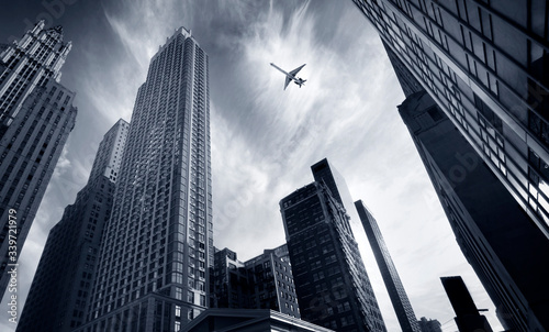 skyscrapers and airplane in sky in new york © Mikael Damkier
