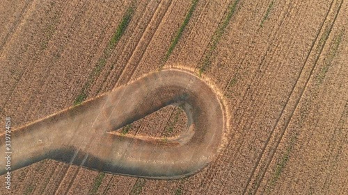 Trace from the harvester in the wheat field in the form of a loop, aerial view