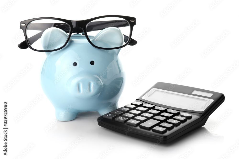 Calculator with piggy bank and eyeglasses on white background Calculator with piggy bank and eyeglasses on white background