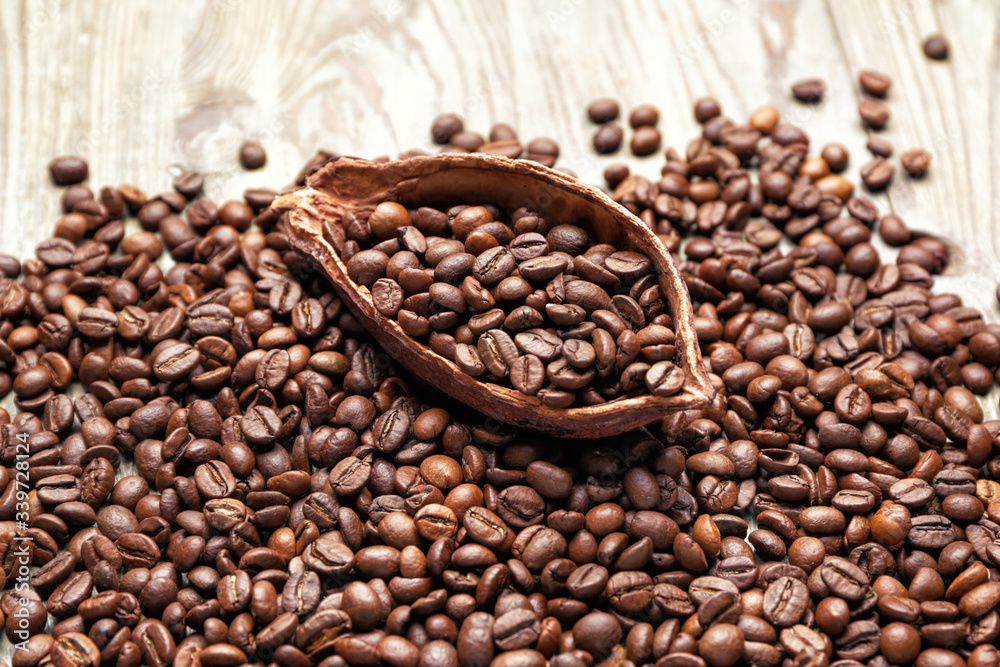 Many coffee beans with cacao pod on table Many coffee beans with cacao pod on table