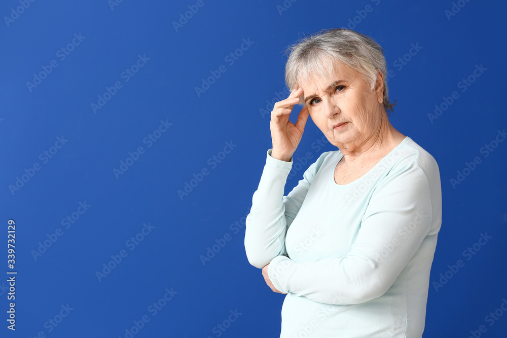 Elderly woman suffering from mental disability on color background Elderly woman suffering from mental disability on color background