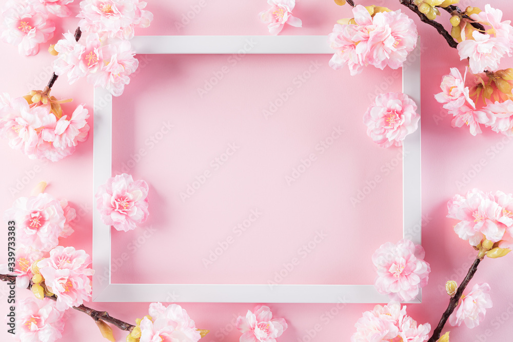 Happy Mother's Day, Women's Day or Valentine's Day greeting concept. Pastel Pink Colours Background with picture frame and blossom flowers flat lay patterns.