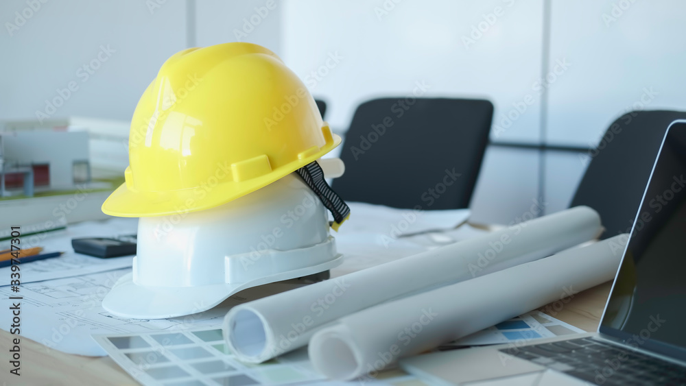 Architect or engineer working in office with blueprints,engineer inspection in workplace for architectural plan,sketching a construction project ,selective focus,Business construction concept. Architect or engineer working in office with blueprints,engineer inspection in workplace for architectural plan,sketching a construction project ,selective focus,Business construction concept.