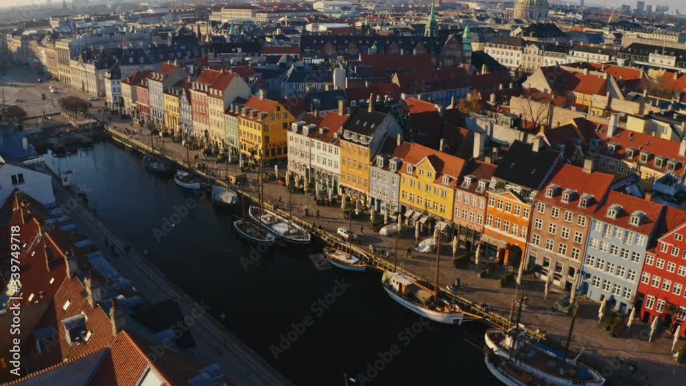 Nyhavn entertainment district in golden sunset with colorful houses from drone
