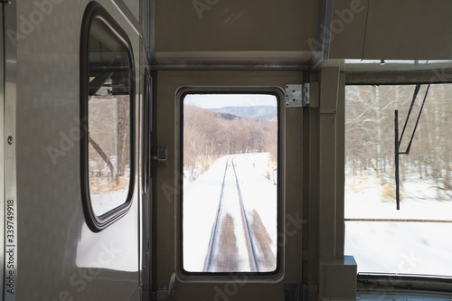 The train tracks in Hokkaido are covered by snow along the route.