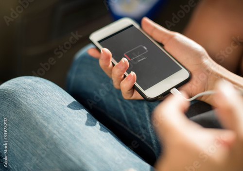 Принти на полотні Close up of hands charging mobile phone