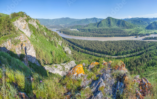 View of the Katun river valley, Altai. Sunny day in early summer. Travel and vacation in the mountains.